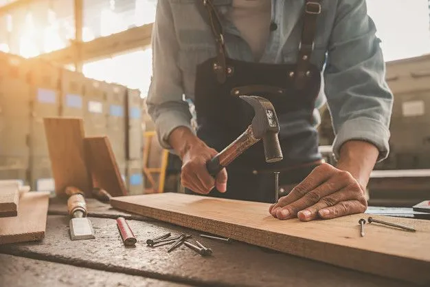 Carpenter working with equipment on wooden table in Dammam